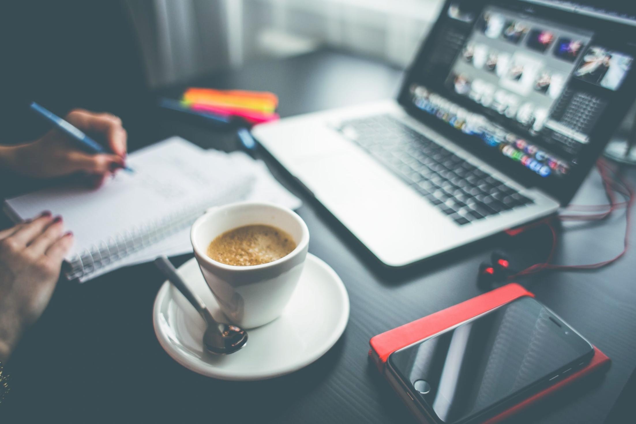 Modern workspace showing laptop and financial documents for budget monitoring